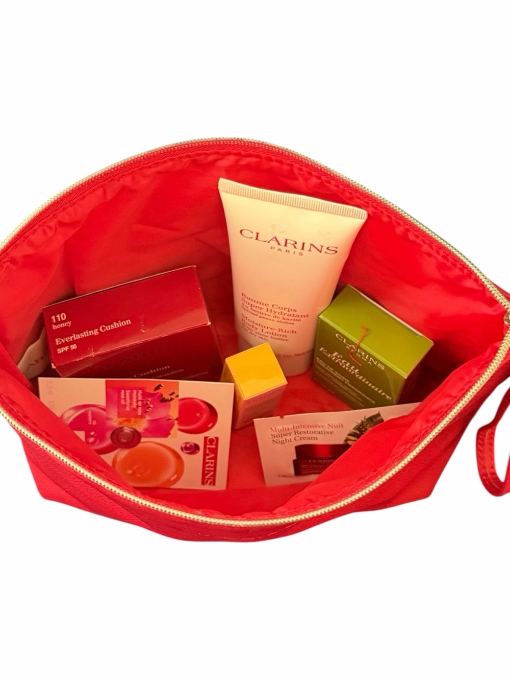 Clarins Gift Set w Red Clarins Bag W Eau Extraordinaire, SPF Cushion, Lotion +